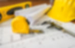 construction-plans-with-yellow-helmet-drawing-tools-bluep.jpg