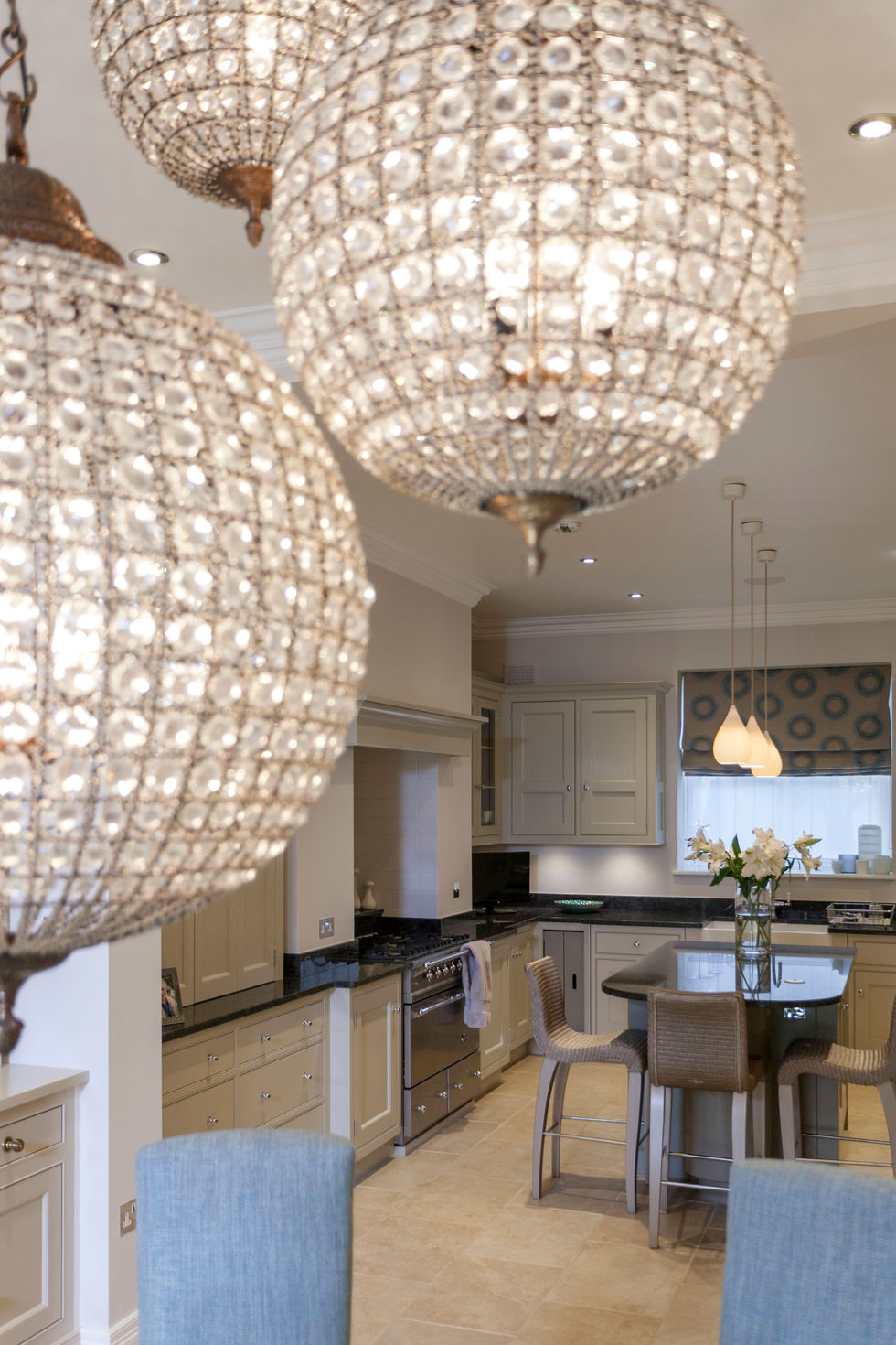 a kitchen with white cabinets and black counter tops