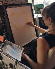 Karen live-drawing a baby elephant, an original artwork to be partially donated as a bid item, at Katie's Night in 2017.