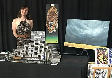 Karen standing next to her vendor display at Katie's Night in 2018 in Denver, CO