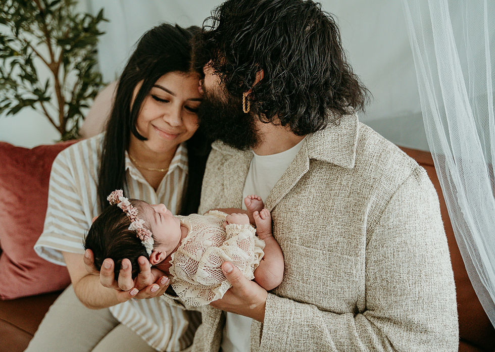 Newborn photography session in Baltimore City – family cuddling on couch
