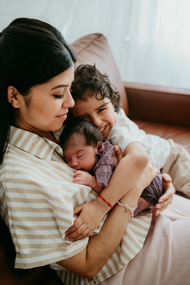 Baltimore lifestyle newborn photos – baby curled in mom’s arms