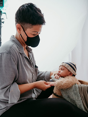 Tasha Sojka Photography posing a baby in a bucket in her Baltimore studio