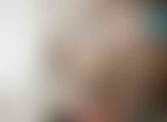 Mom looking at cute outfits for her newborn photoshoot in a fully stocked newborn photography studio in Baltimore Maryland