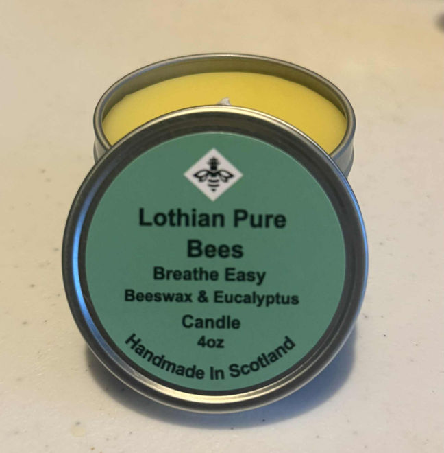 Lothian Pure Bees Breathe Easy beeswax and eucalyptus candle tin, open candle showing yellow beeswax