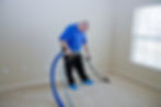 Man cleaning carpet with commercial cleaning equipment