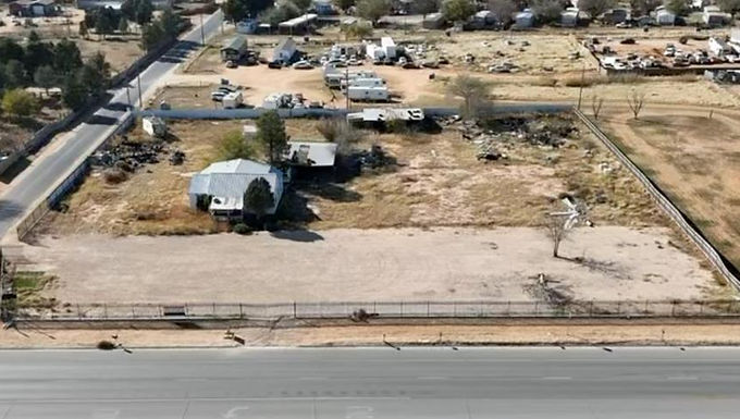 Spacious 2-acre fenced lot for lease at $2,500/mo with $2,500 deposit. Partially cleared and ideal for parking trucks, semis, trailers, or equipment. Features metal and wrought-iron fencing with oversized gates on WCR 137 and S Hwy 349 for easy access. Rear structure is dilapidated and not in use. No restrictions—endless possibilities for storage or commercial use.