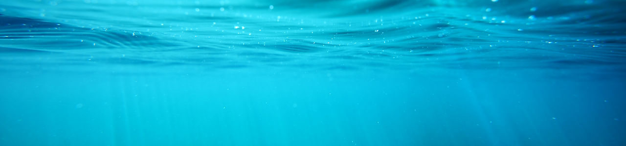 underwater-view-with-sun-beams-in-turquoise-water-SBI-300739790.jpg