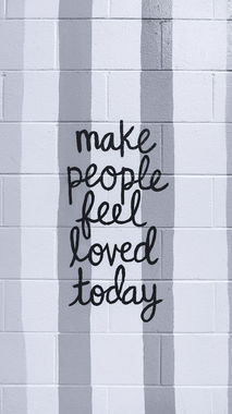 Words on brick wall say 'make people feel loved today'. Image by Clay Banks on Unsplash