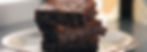 close-up-image-of-three-chocolate-brownies-on-white-plate-by-arantxa-aniorte-on-unsplash