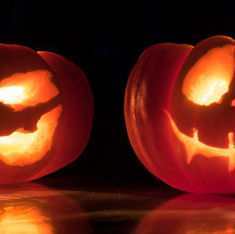 two-carved-pumpkins-glow-with-reflection-from-wix-media