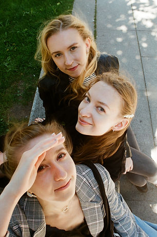 three-slightly-smiling-women-with-fair-hair-look-upward