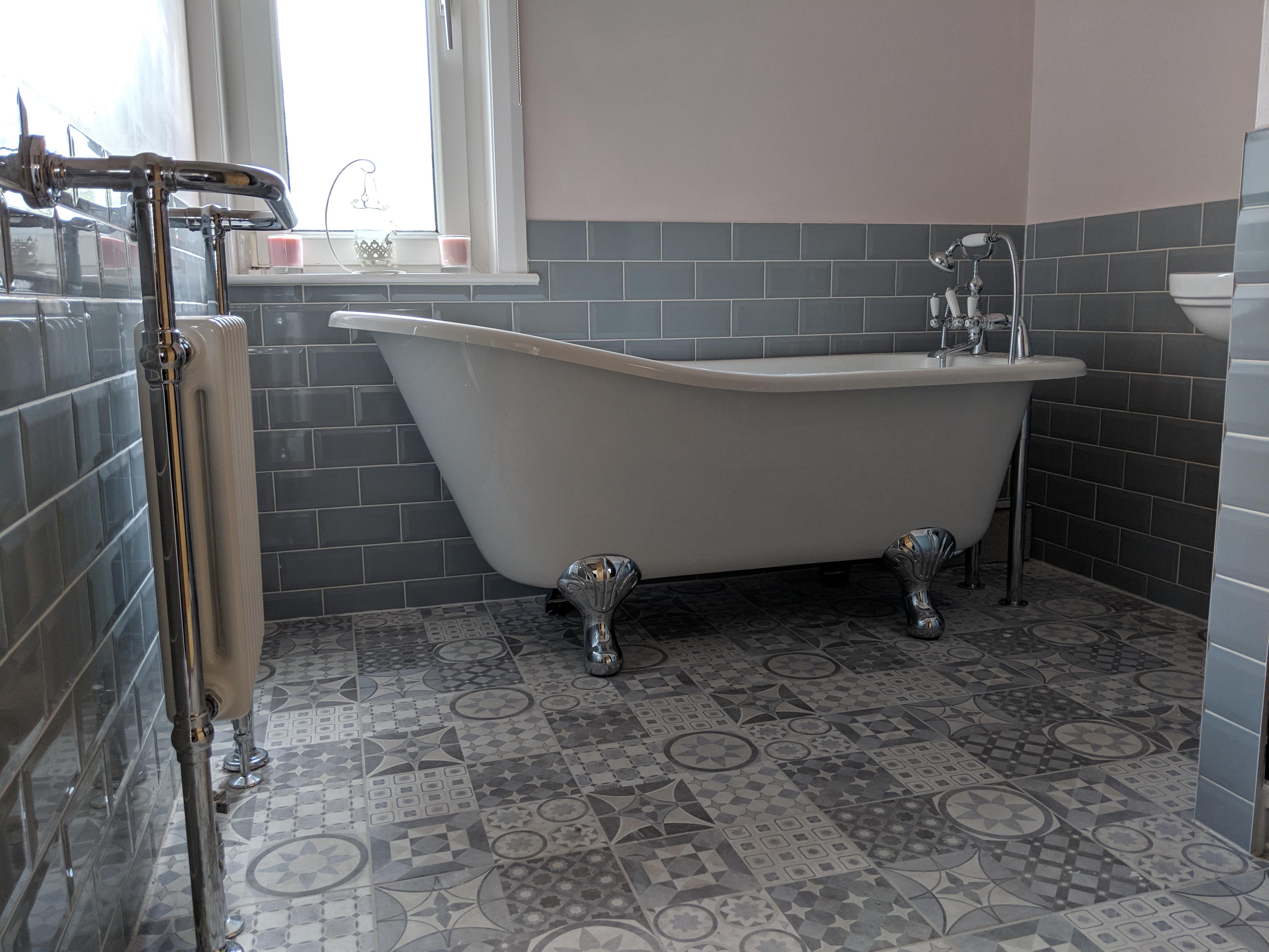 slipper bath on random tiled floor