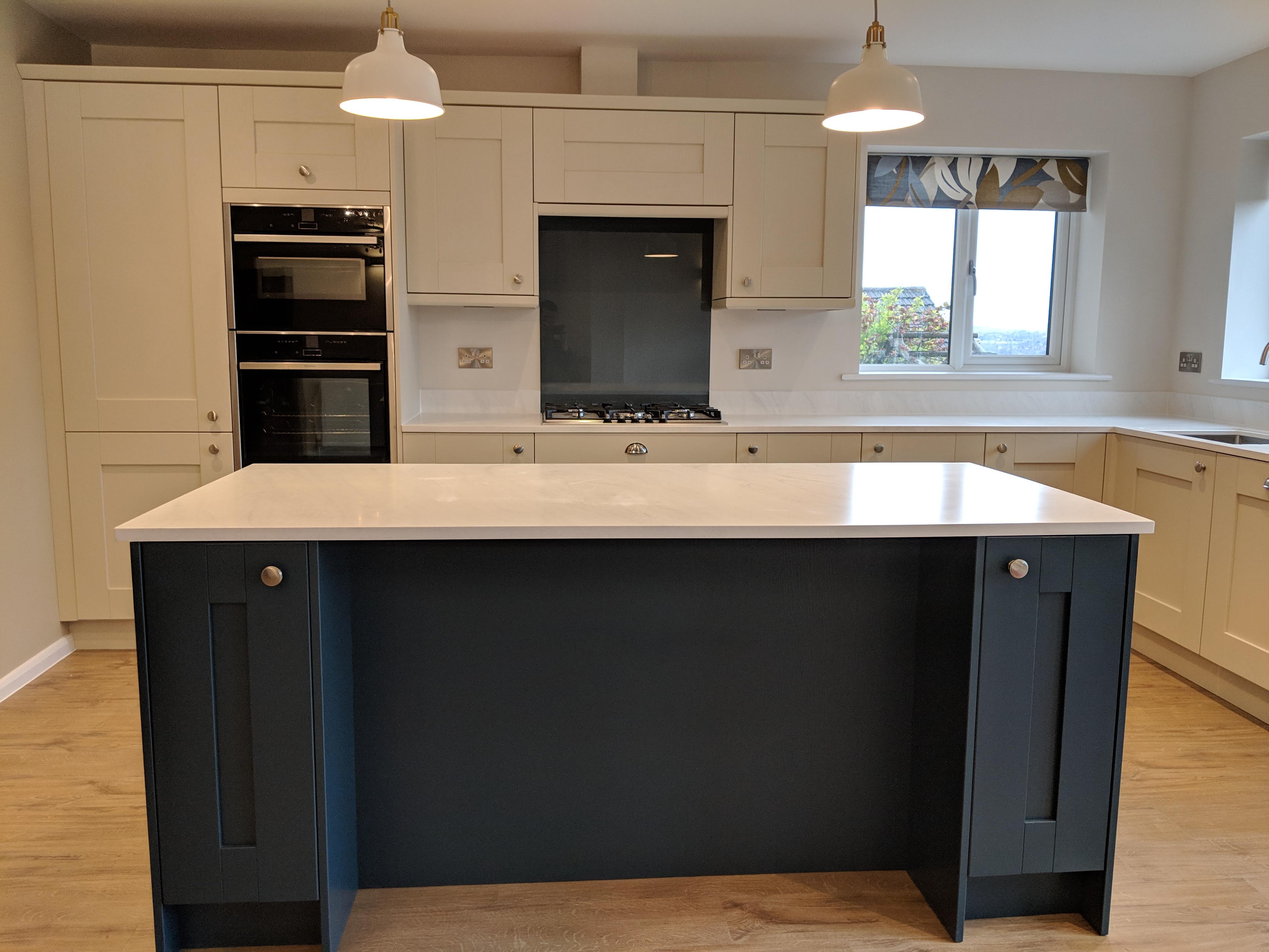 shaker kitchen with dark blue island uni