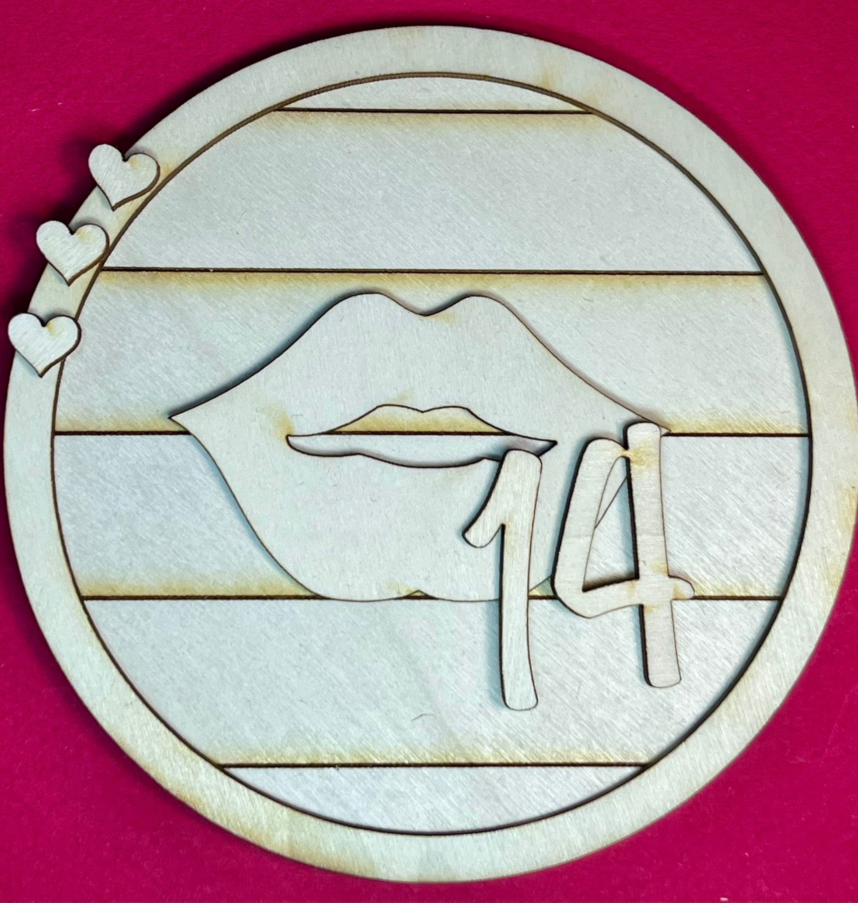 Round Valentine craft kit insert featuring a set of lips and the number 14 with small heart accents on a shiplap background.