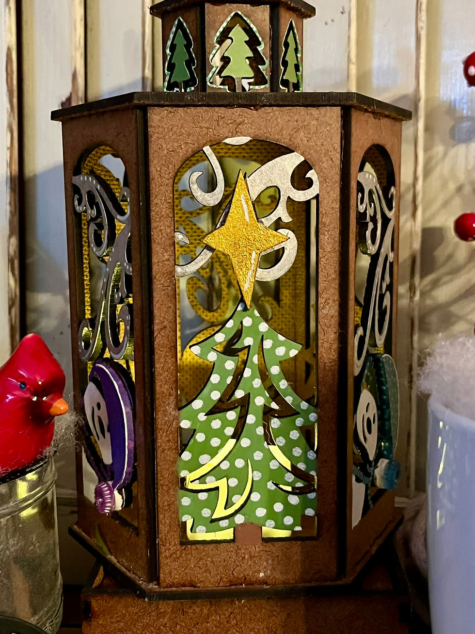 Thumbnail: Painted winter lantern craft kit with green Christmas tree and yellow star, shown finished in festive holiday display