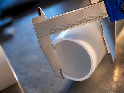 Caliper measuring PVC pipe outside diameter