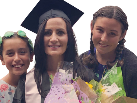 Mom graduate with her two daughters