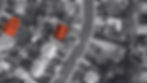 black and white areal image of a street neighborhood. homes are outlined and highlighted in red.