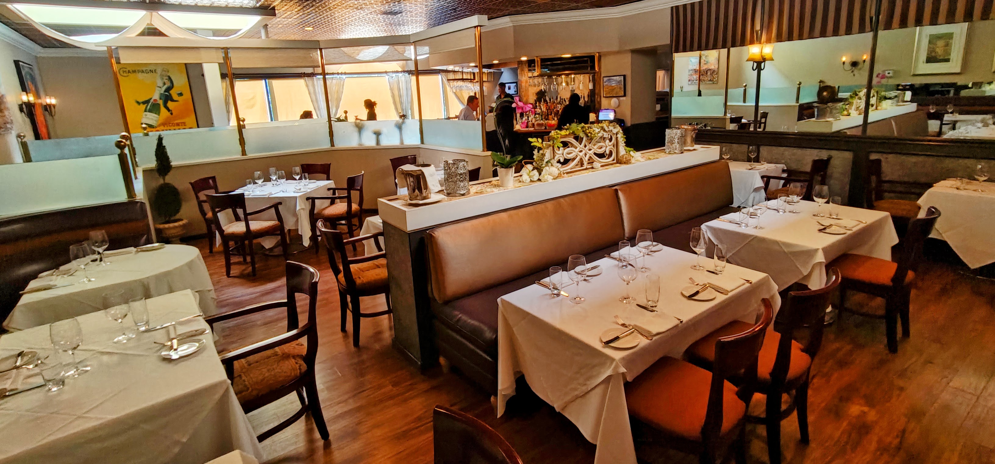 A wide view of a modern French restaurant interior ready for a full venue buyout.