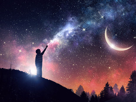 Child silhouette points at a glowing star under a colorful Milky Way sky with crescent moon above dark trees.