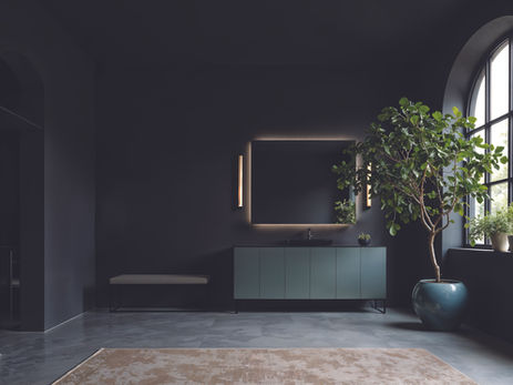 Dark modern bathroom with lit vanity, arched window, potted tree, bench, and beige rug; calm, minimalist mood.