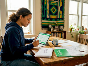 Graduate reviewing student loan repayment documents