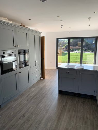 New modern kitchen with wooden floors, high-end appliances, and stone worktops – expert kitchen installation UK