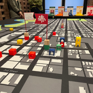 A close up of a map of downtown Columbus, IN with wooden blocks placed on various city blocks