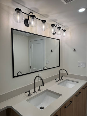 Bathroom with double sinks and large mirror.