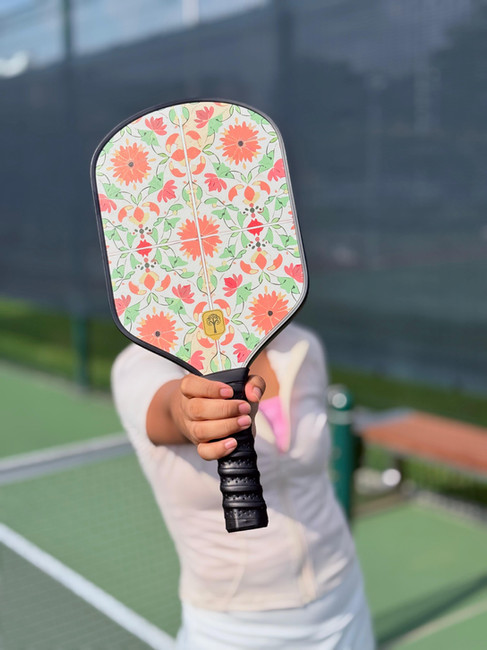 female holding pickleball paddle singapore