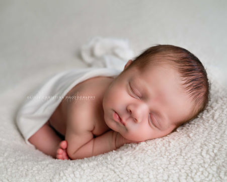 Sleeping newborn baby boy on soft cream Hertford photographer
Stevenage Baby Photography | Miniature Wooden Bed Prop Setup