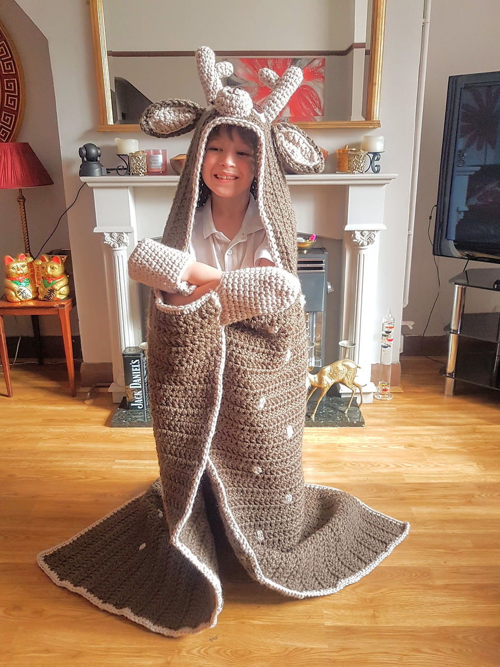 Thumbnail: Kid wearing Woodland Deer Crochet Pattern Hooded Blanket