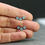 Thumbnail: Light Blue Enameled Dainty Earrings on hand