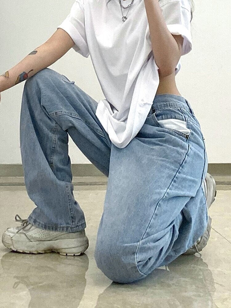 Thumbnail: Misplaced Button High Waisted Ripped Jeans Model Sitting