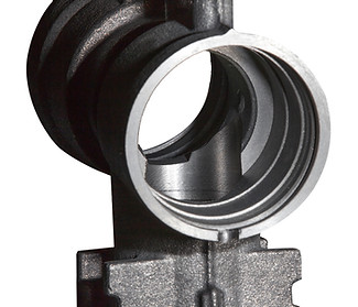 Carbon-steel automotive combustion component precision-machined by HRB Industries, high-aspect geometry.