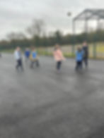 Students playing football game outdoors