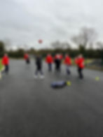 Students playing soccer game outdoors
