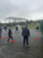 Students playing tennis outdoors