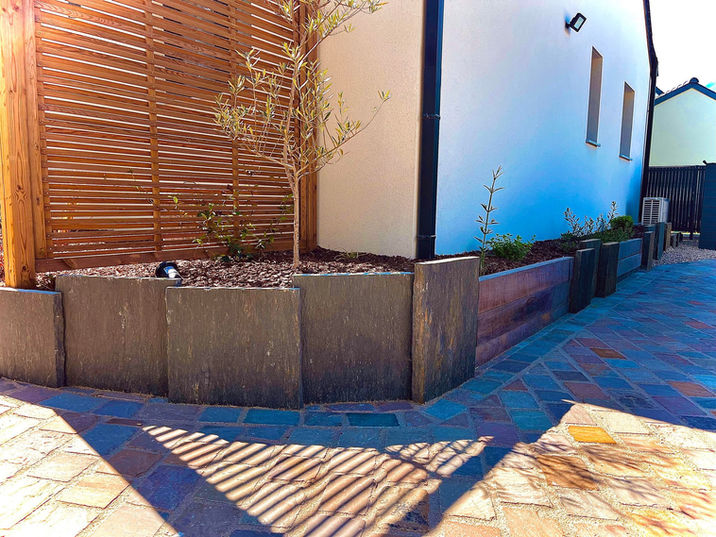 Jardinière en palis de schiste et traverse exotique avec plantations et panneau décoratif en bois - Albizia Paysage, Saint-Quay-Portrieux, Côtes-d’Armor