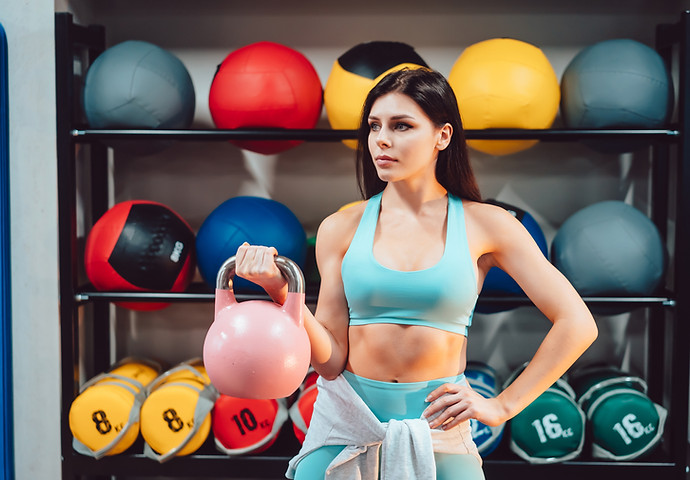 young-adult-woman-doing-strength-exercises-gym.jpg