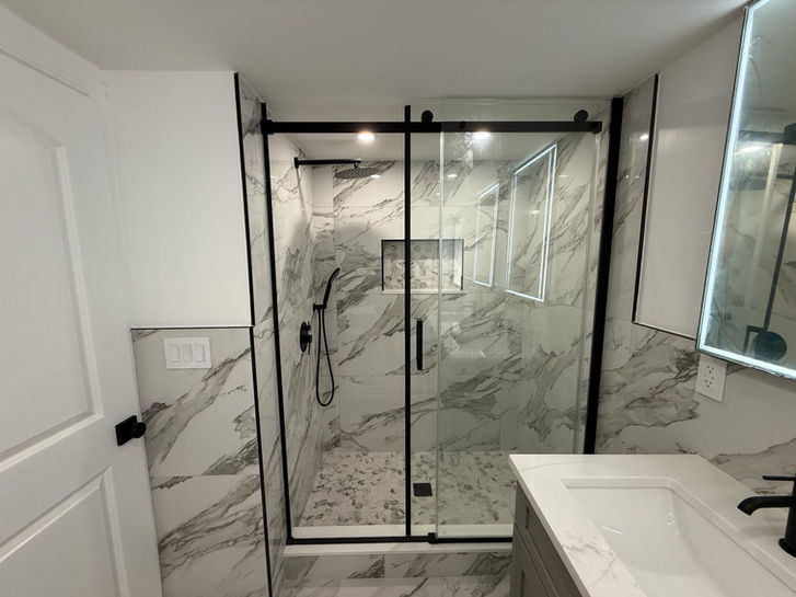 modern marble bathroom remodel with walk in shower double vanity and led mirrors in paramus nj