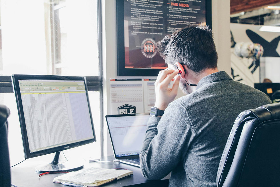 CX quality assurance specialist analyzing support data on dual monitors.
