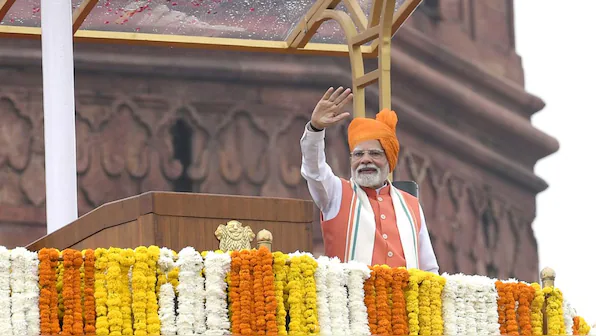 Prime Minister Narendra Modi waves from the ramparts of Red Fort, New Delhi, on Independence Day on August 15, 2025. (Photo: Press Information Bureau) | Firstpost