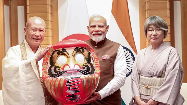 Prime Minister Narendra Modi was presented with a Daruma Doll by the Chief Priest of Shorinzan Daruma Temple in Tokyo, Japan.(PTI) | LiveMint