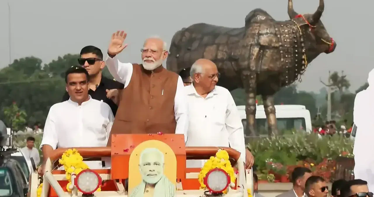 Prime Minister Narendra Modi greets people during a roadshow upon his arrival in Gujarat | NDTV