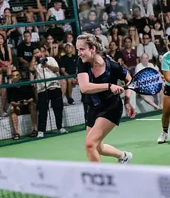 Coach Ceres in action at a tournament, playing a forehand volley