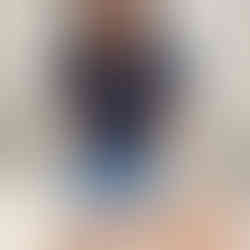 Acupuncturist inserting a needle near the ankle as part of migraine acupuncture treatment.