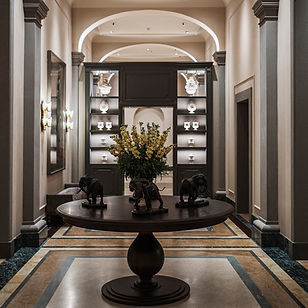 a beautifully decorated room with a table and shelf display