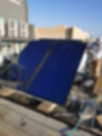 a solar water heater being installed on the roof of a building